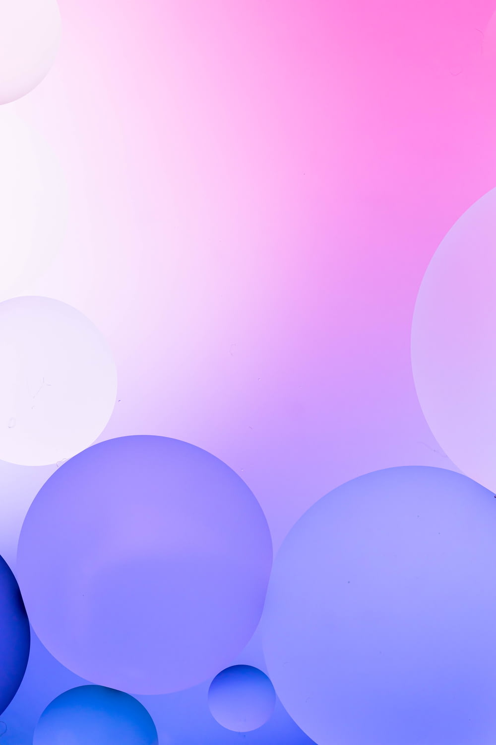 a blue and pink background with bubbles