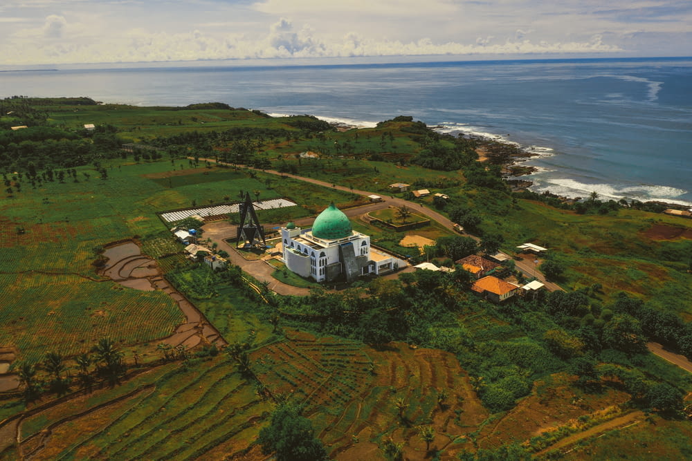 an aerial view of a farm with a church in the foreground