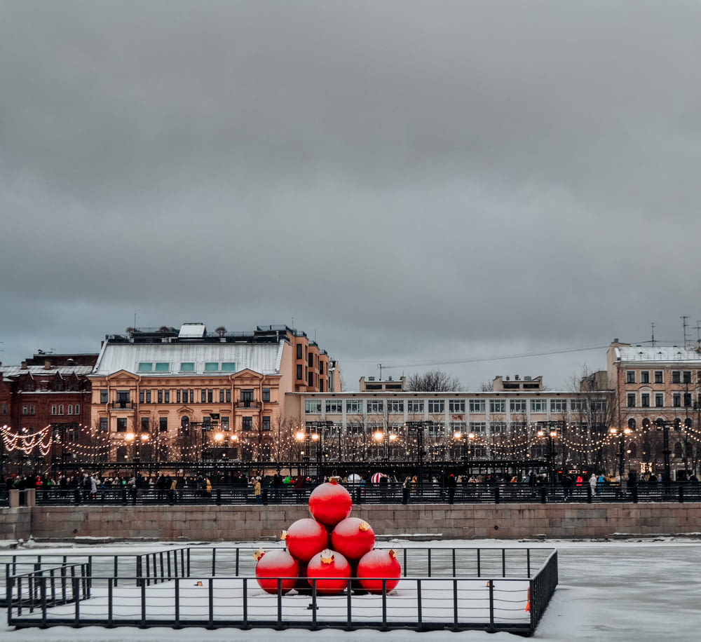 a group of red balls sitting on top of a snow covered ground