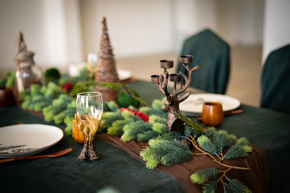 a table with a green table cloth and a centerpiece