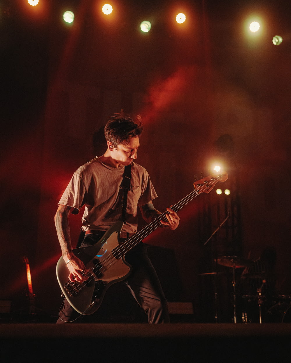 a man playing a bass guitar on a stage