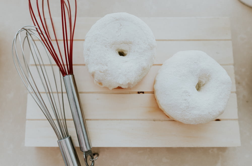 a couple of doughnuts sitting on top of a wooden board