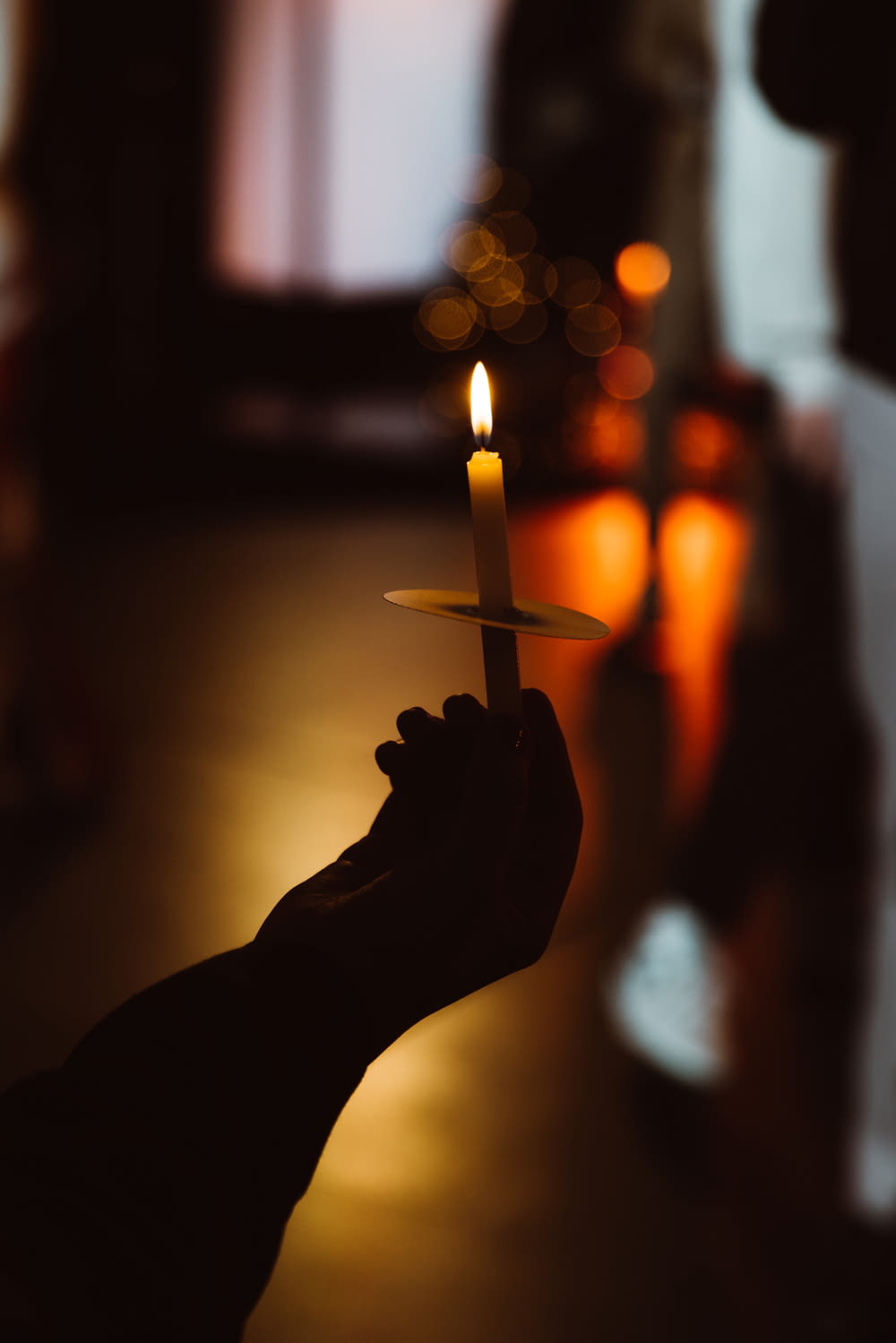 a person holding a candle in their hand