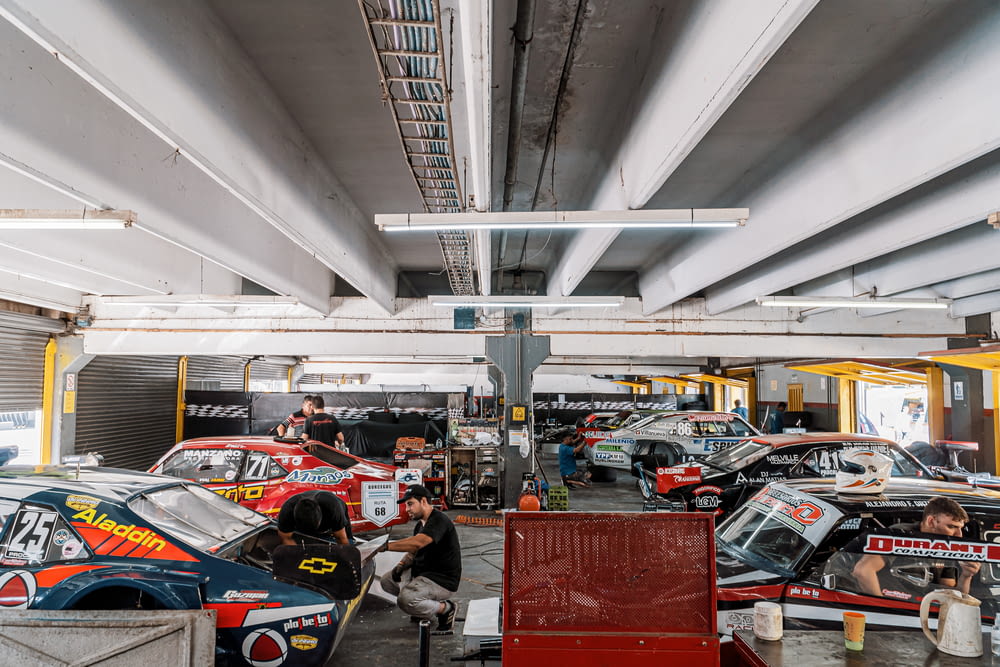 a group of cars parked inside of a garage