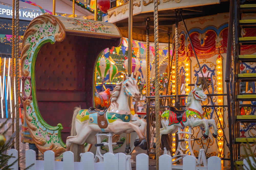 a merry go round with horses and lights