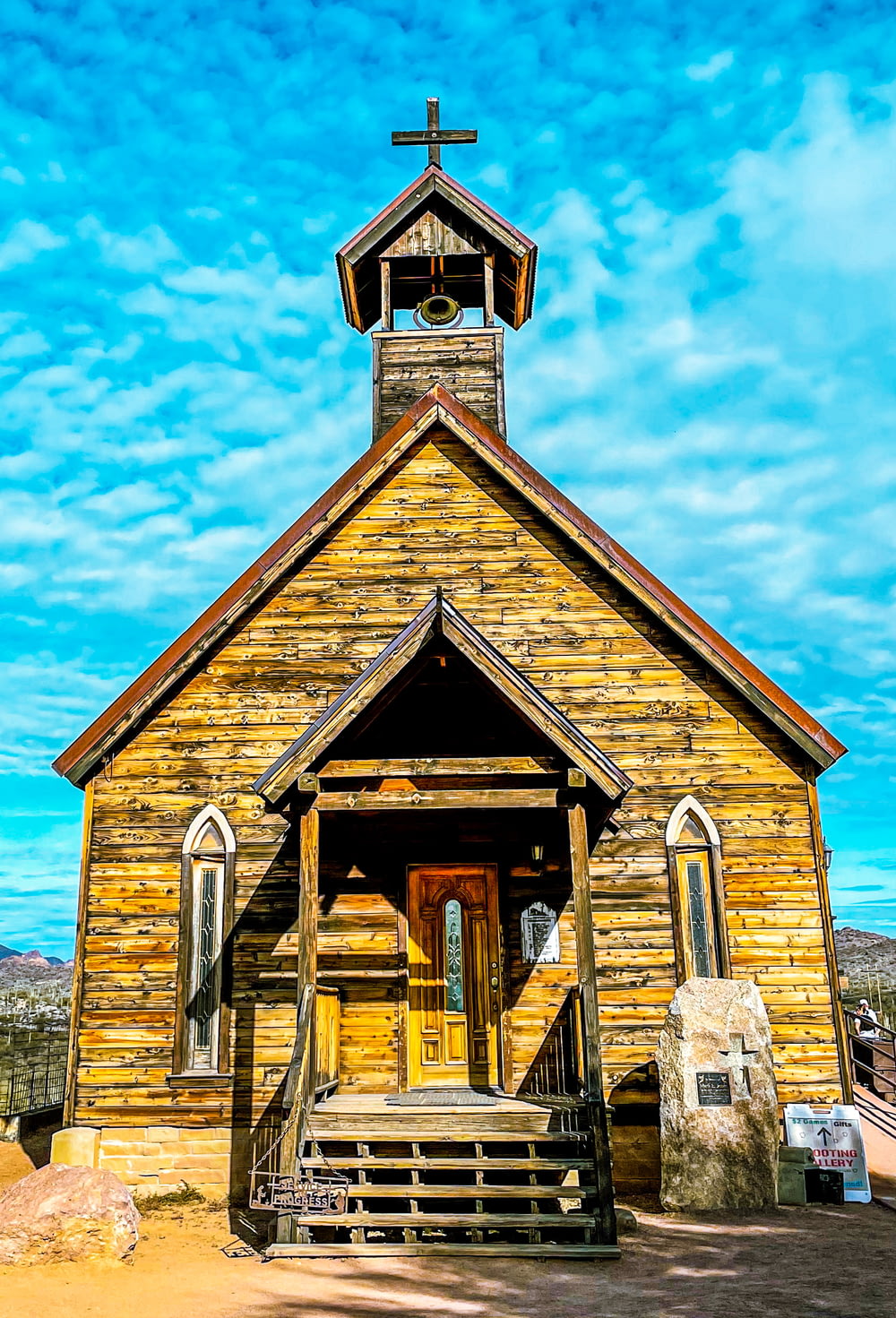 a small wooden church with a cross on top