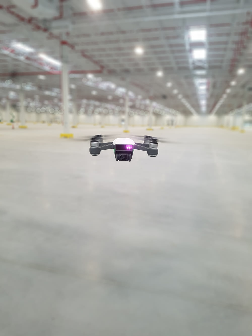 a small remote controlled flying in a warehouse