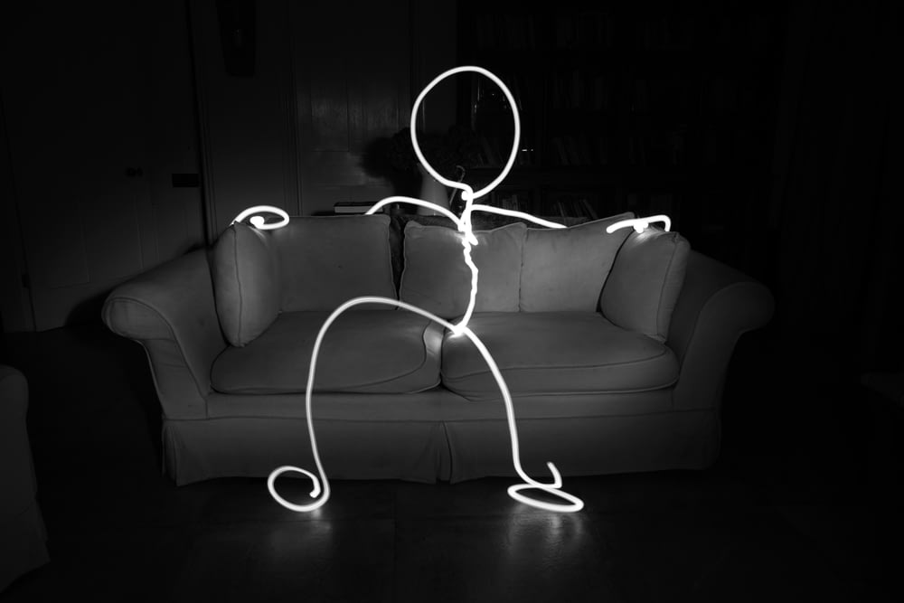 a black and white photo of a person holding a string