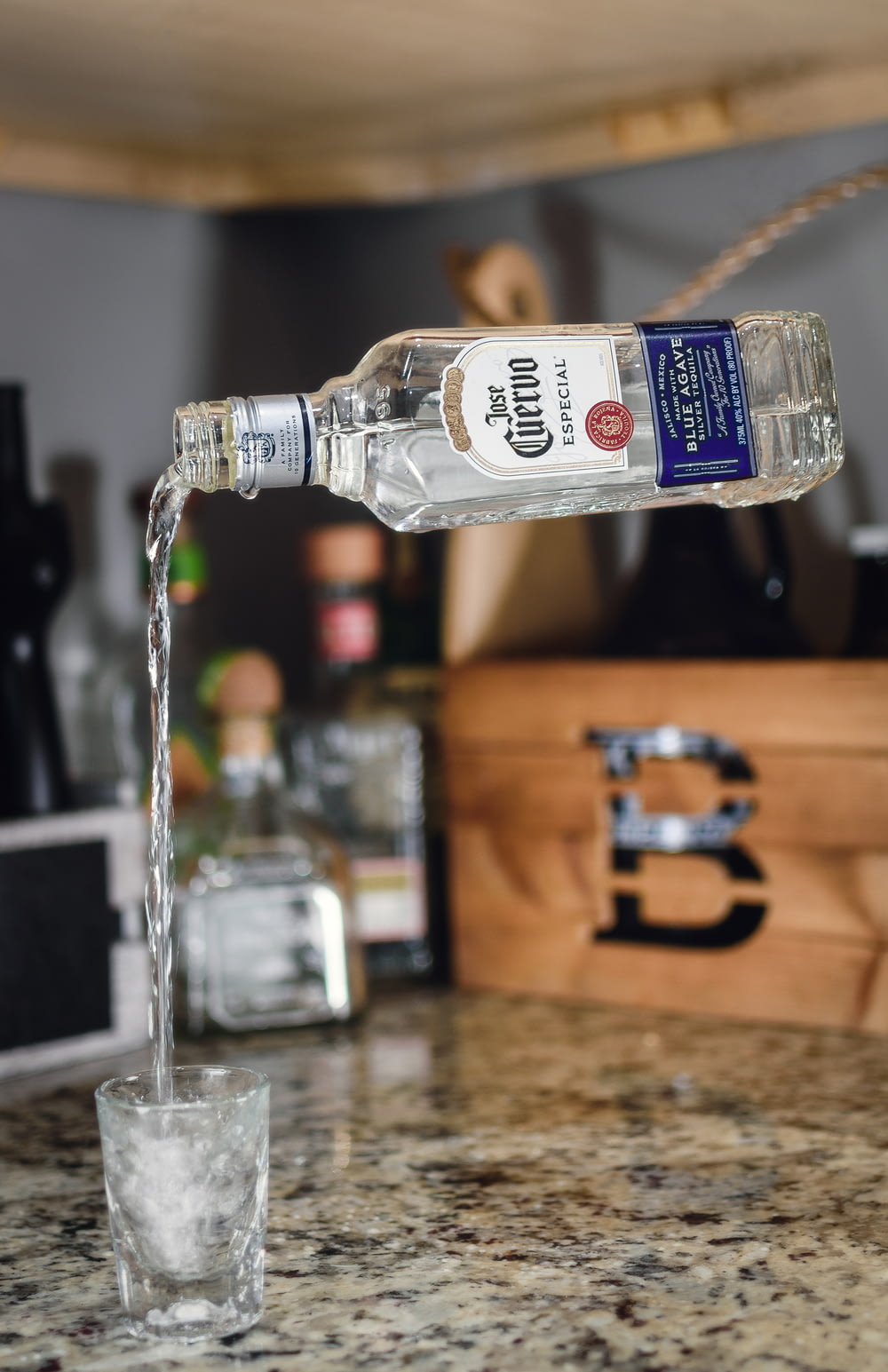 a bottle of vodka being poured into a glass