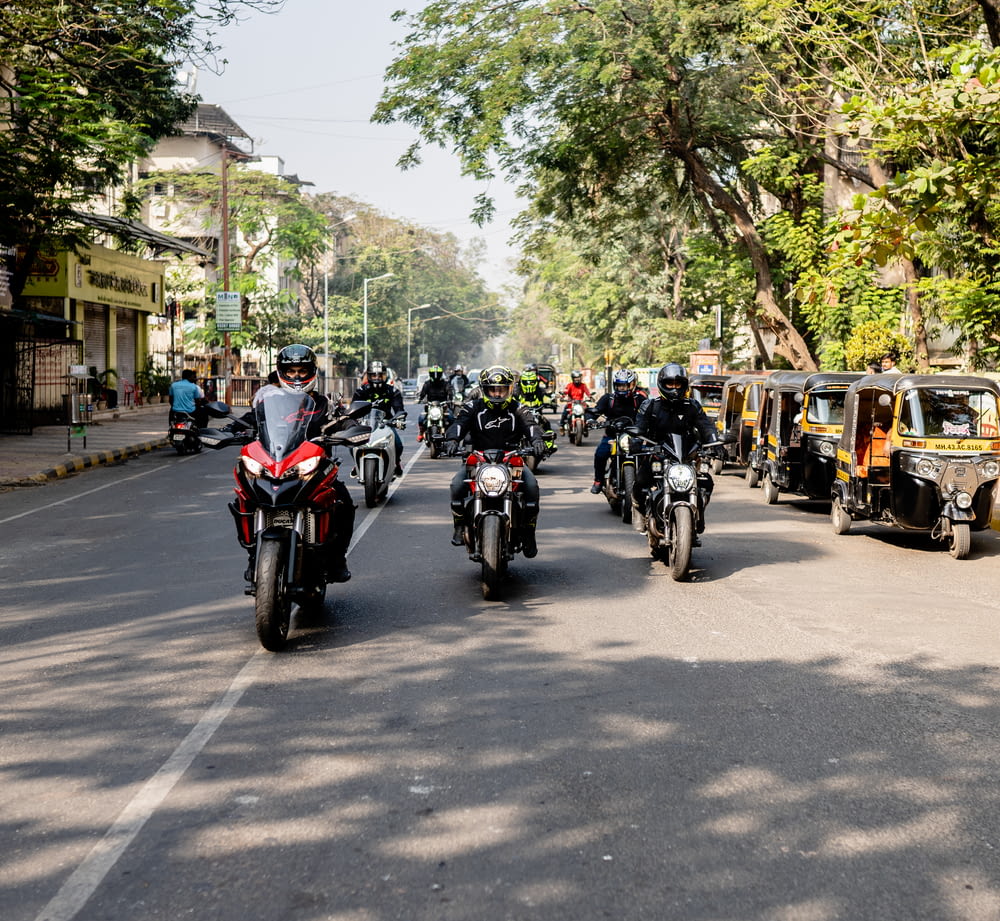 a group of people riding a motorcycle down a street