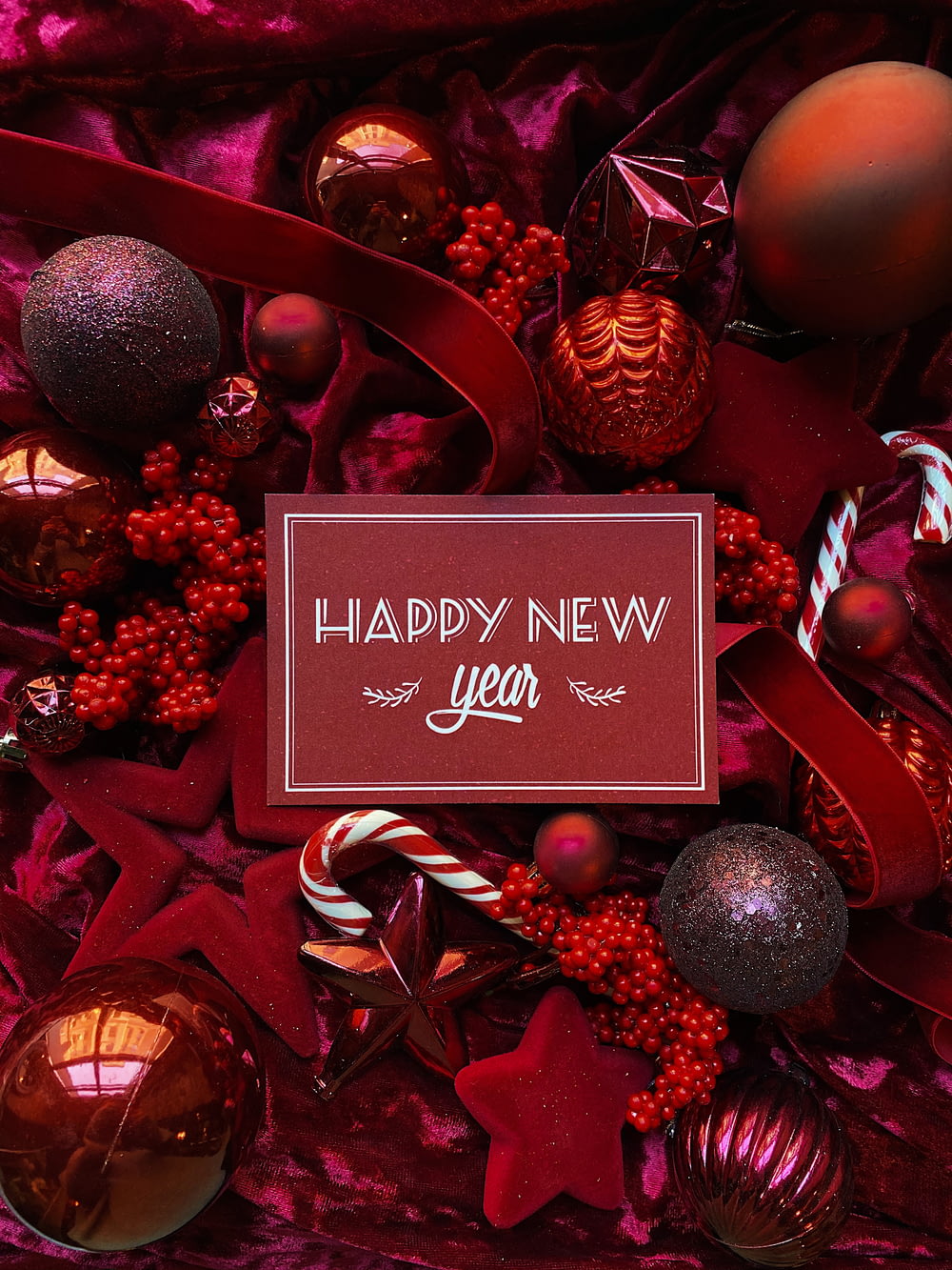 a happy new year card surrounded by christmas ornaments