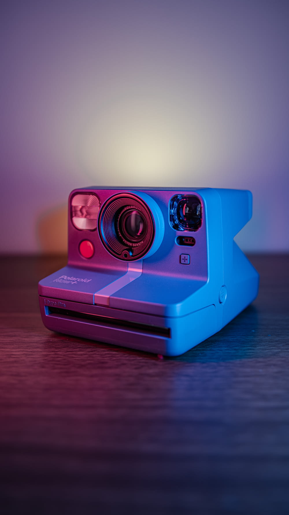 a polaroid camera sitting on top of a wooden table