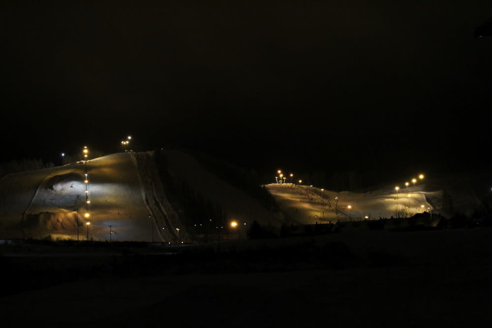 a ski slope lit up at night with lights