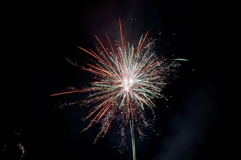 a fireworks is lit up in the night sky