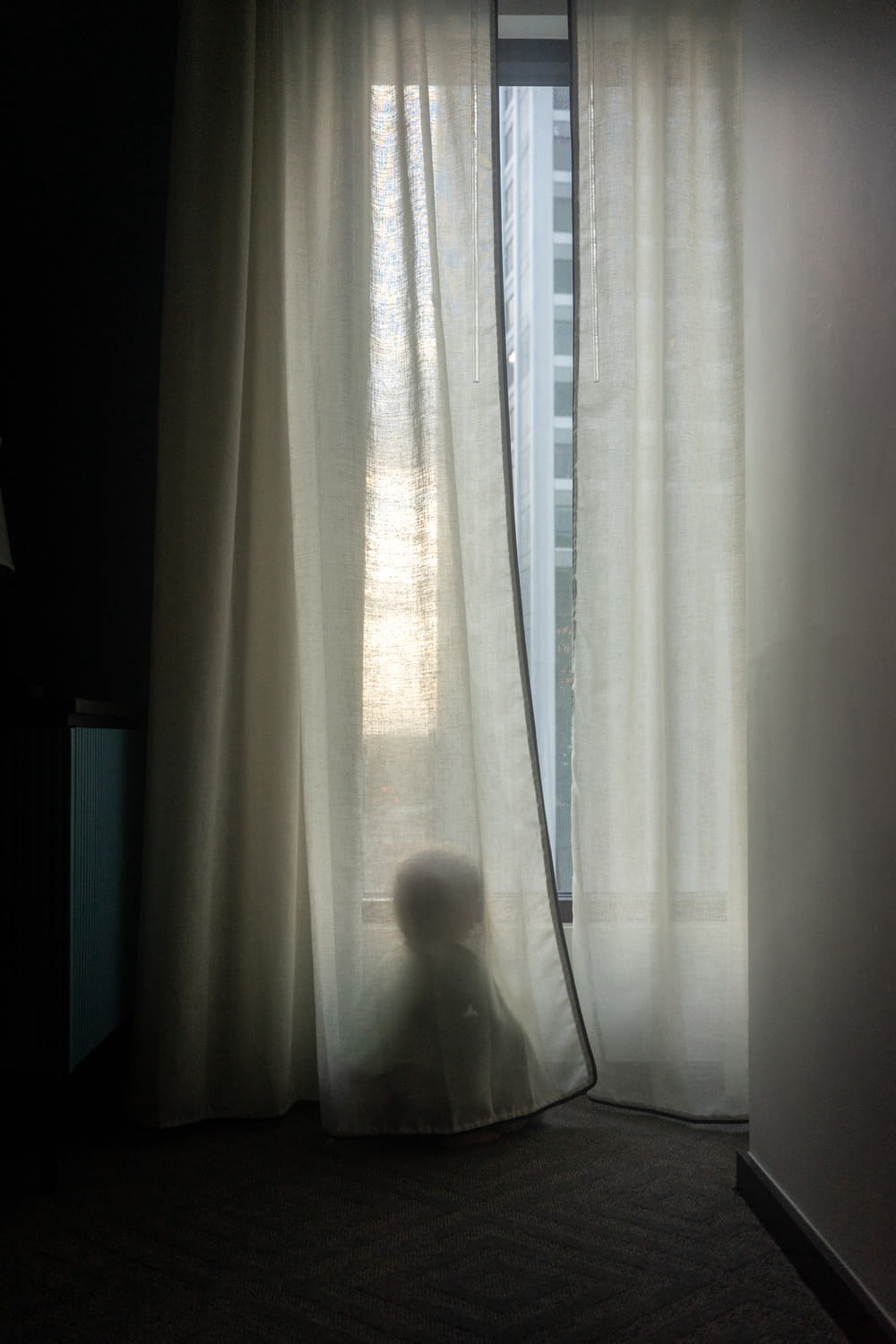 a teddy bear sitting in front of a window