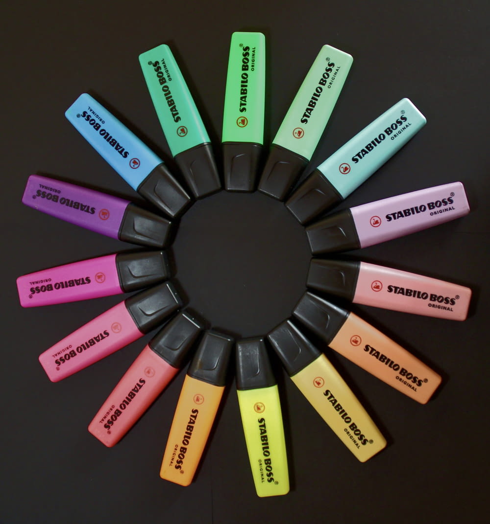a circle of different colored batteries on a table