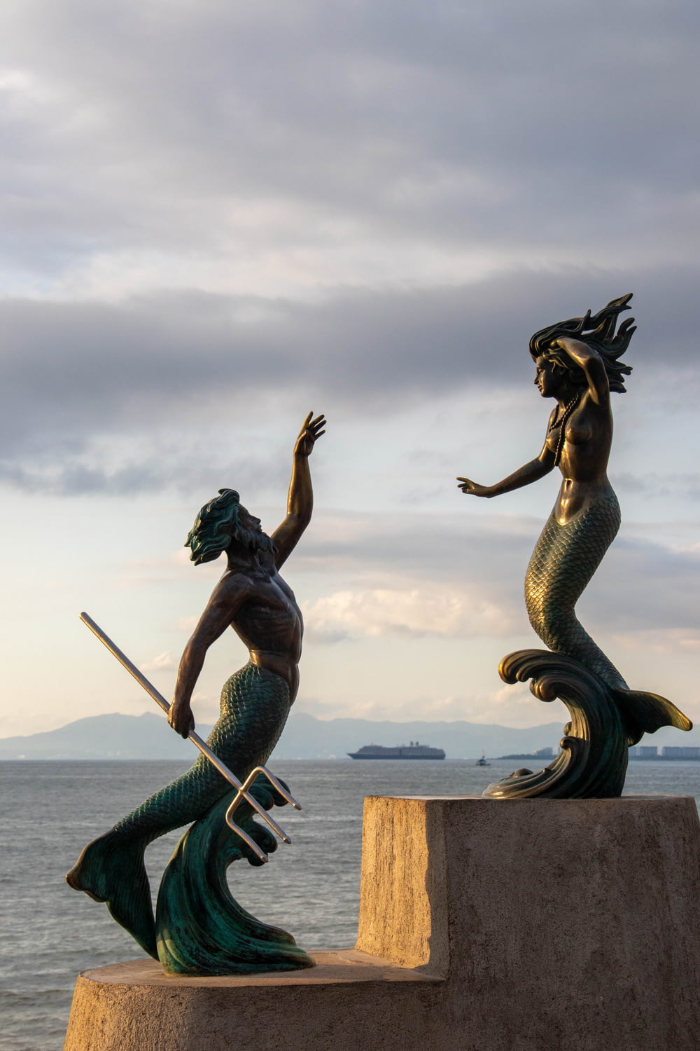 a statue of a mermaid and a mermaid holding a sword