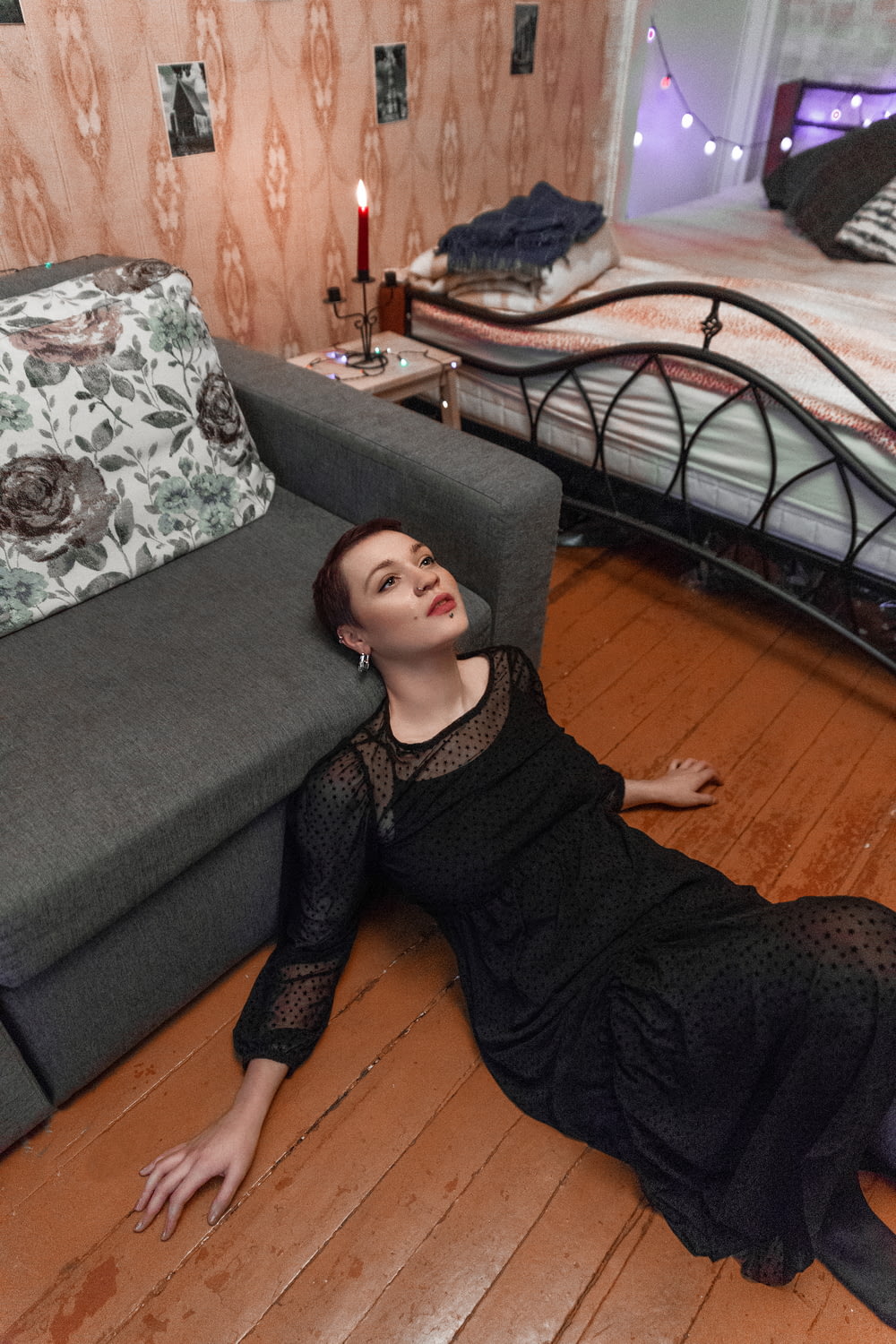 a woman laying on the floor next to a bed