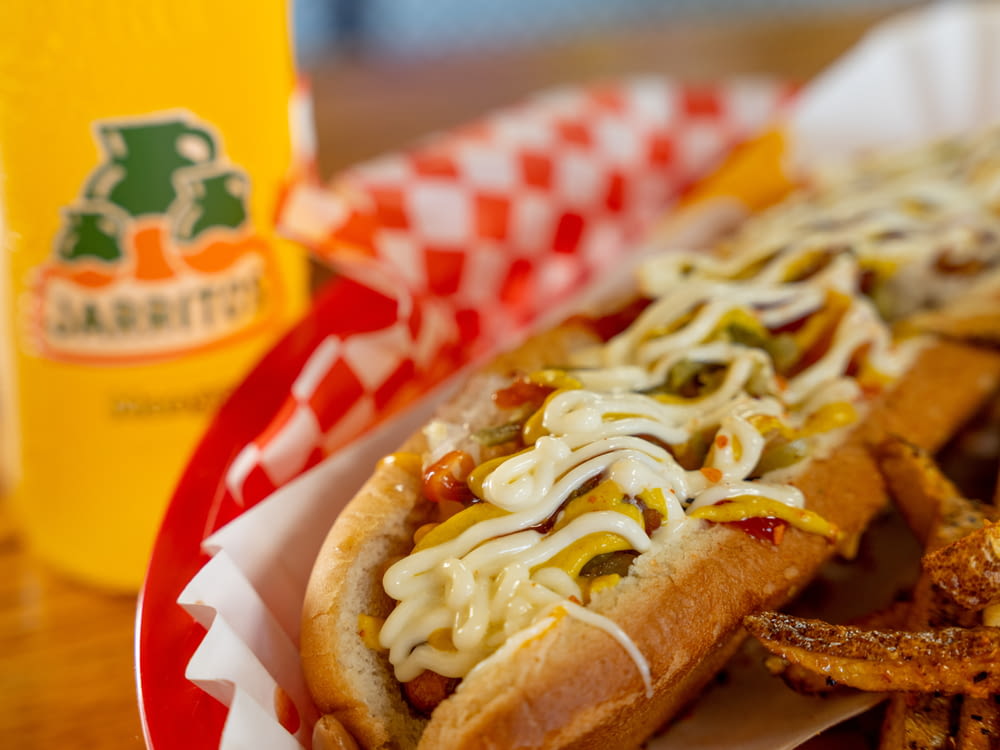 a close up of a hot dog with toppings
