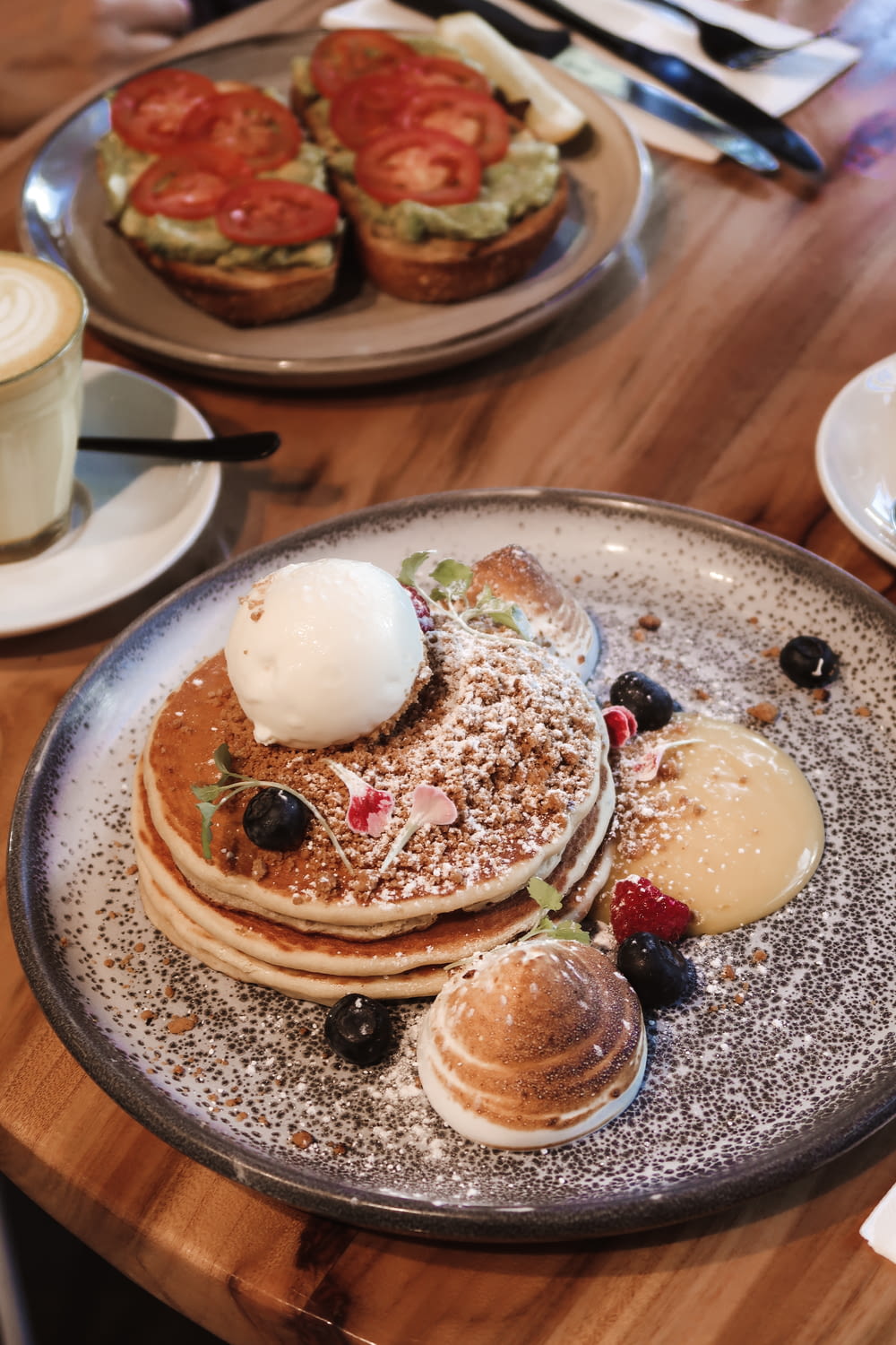 a plate of pancakes and a cup of coffee on a table