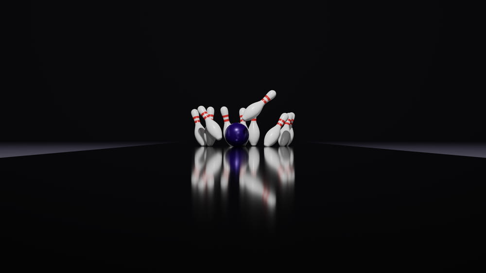 a bowling ball crashing into the pins of a bowling ball