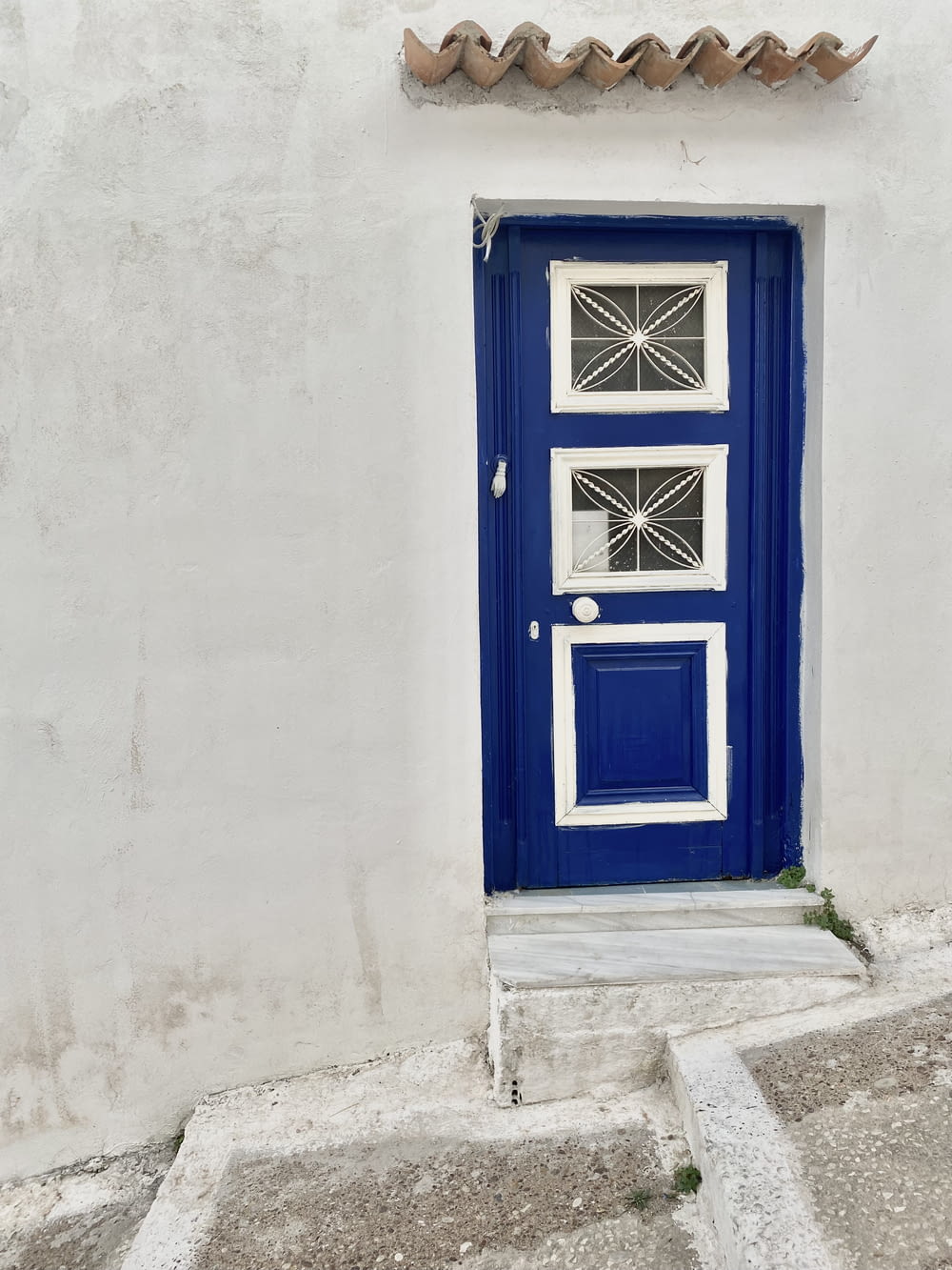 a blue and white door on a white building
