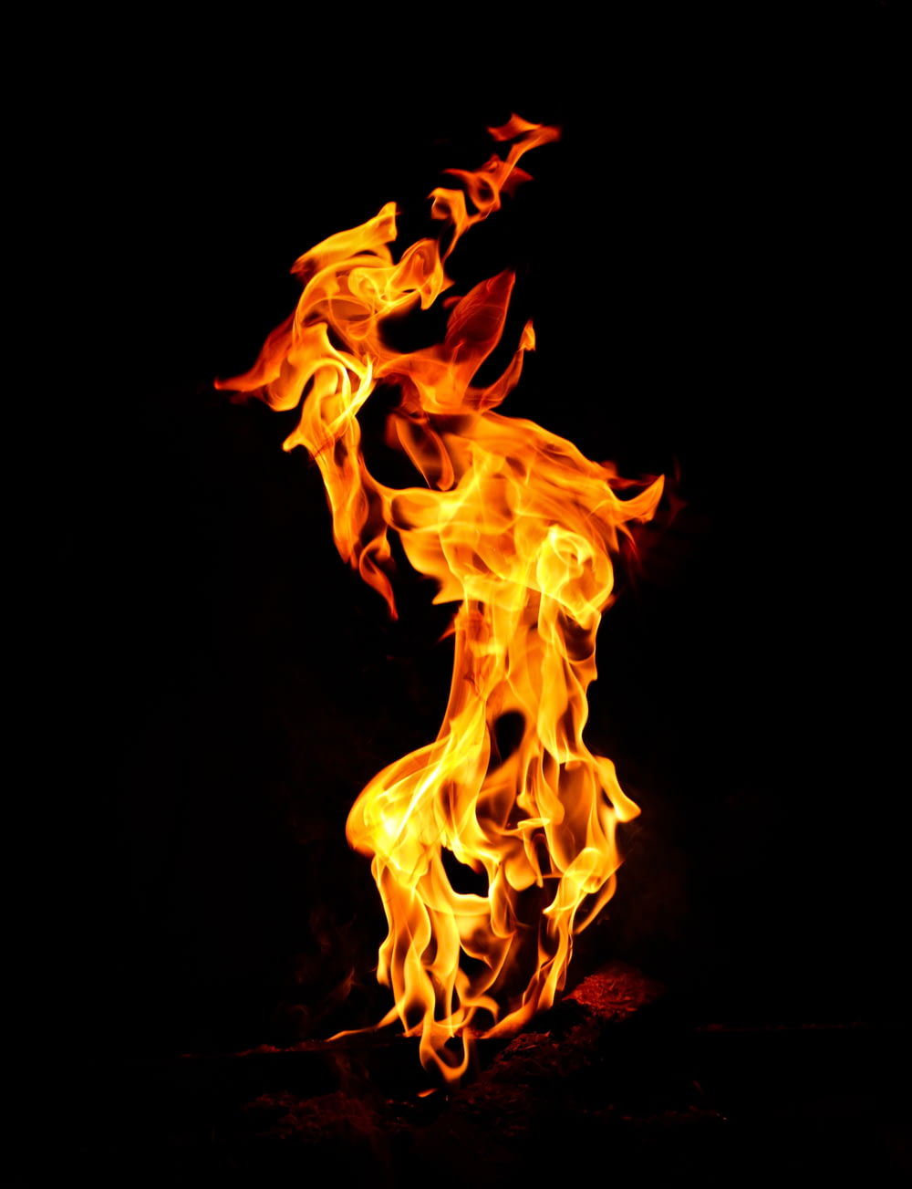 a fire flame is shown in the dark