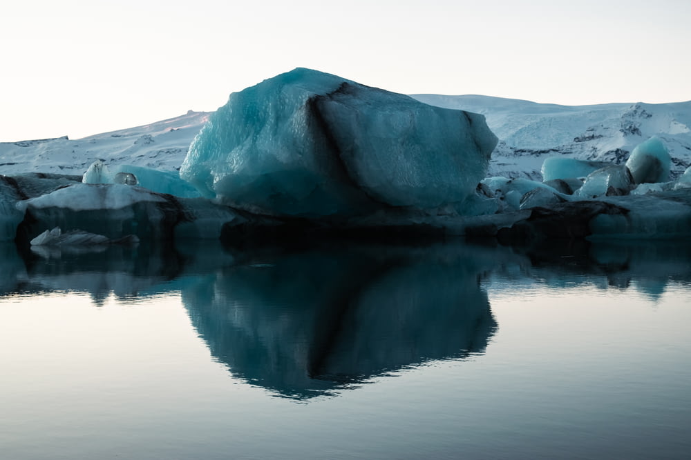 a large iceberg floating in the middle of a lake