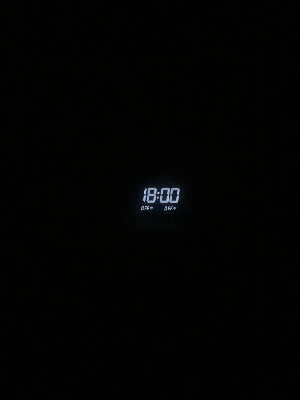 a digital clock is displayed in the dark