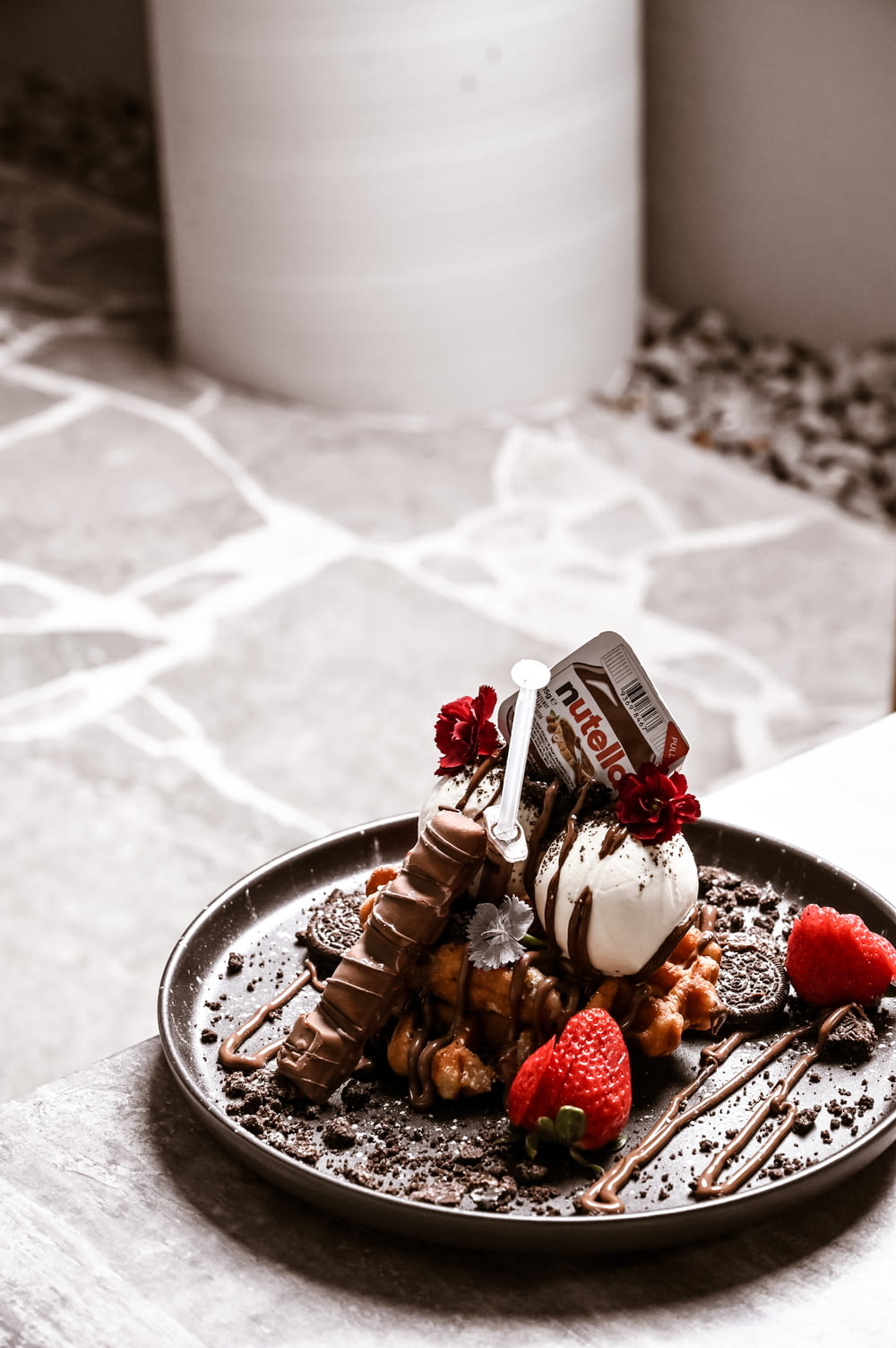 a plate of food with chocolate, strawberries, and ice cream