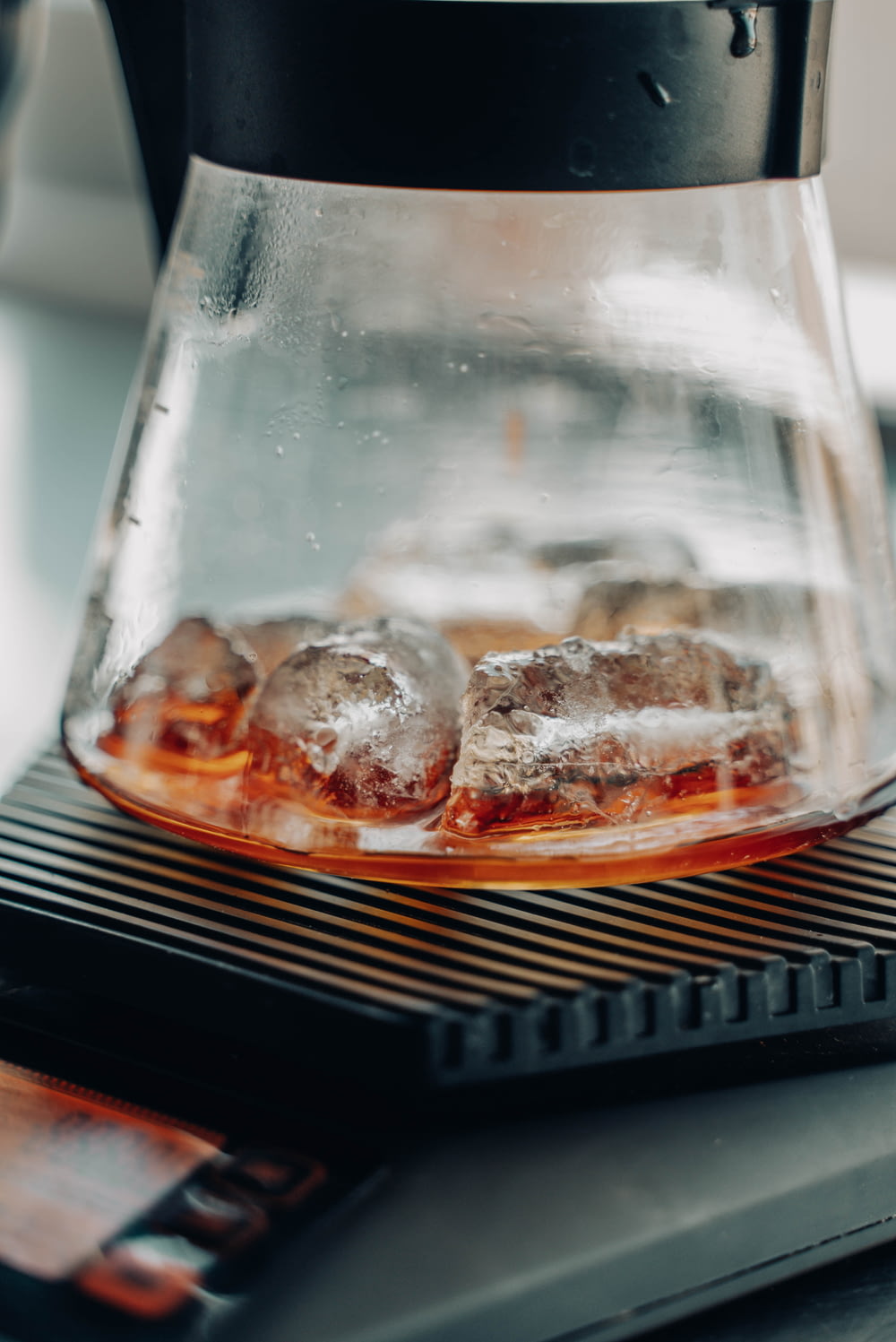 a coffee pot with ice cubes in it