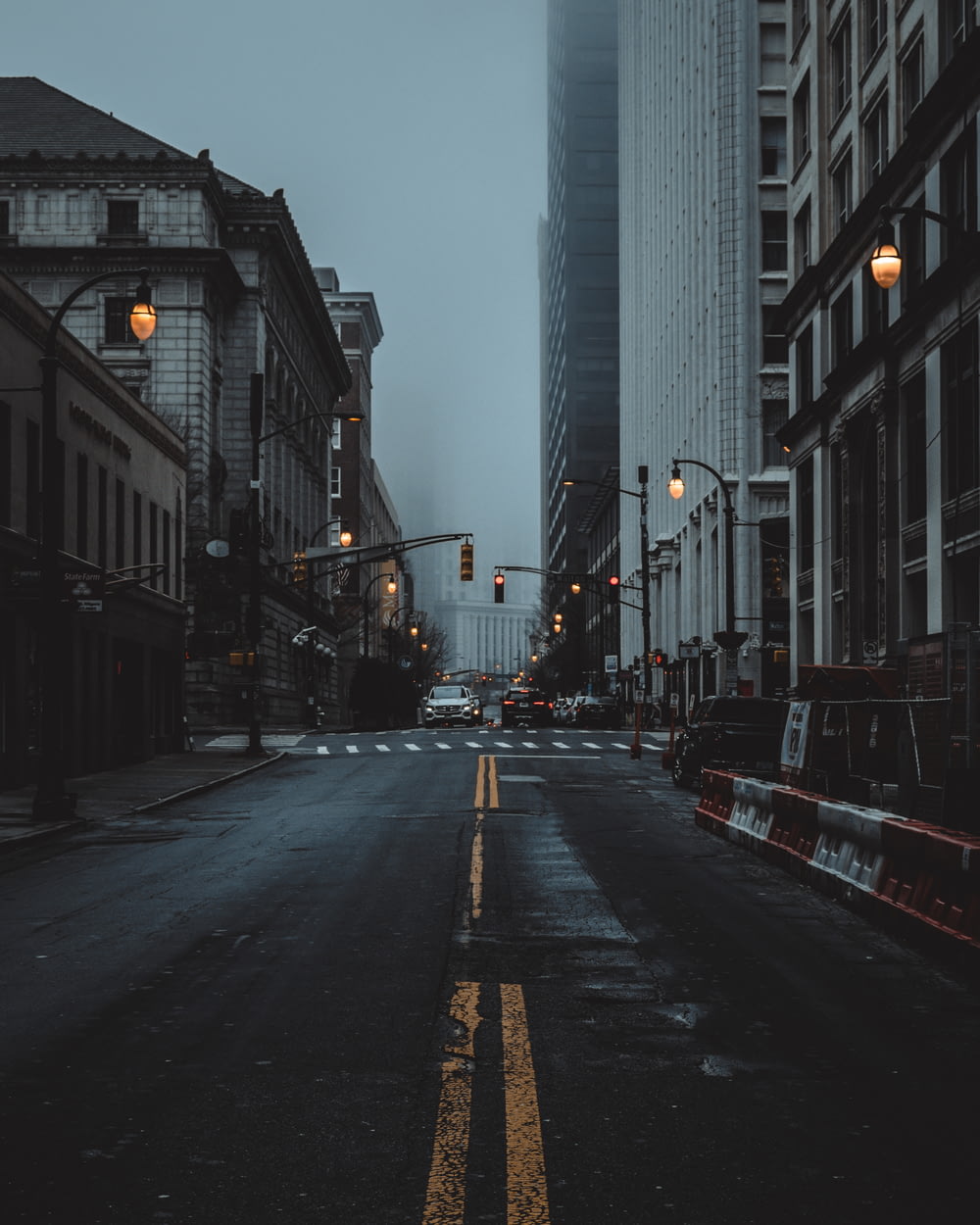 an empty city street at night with a traffic light