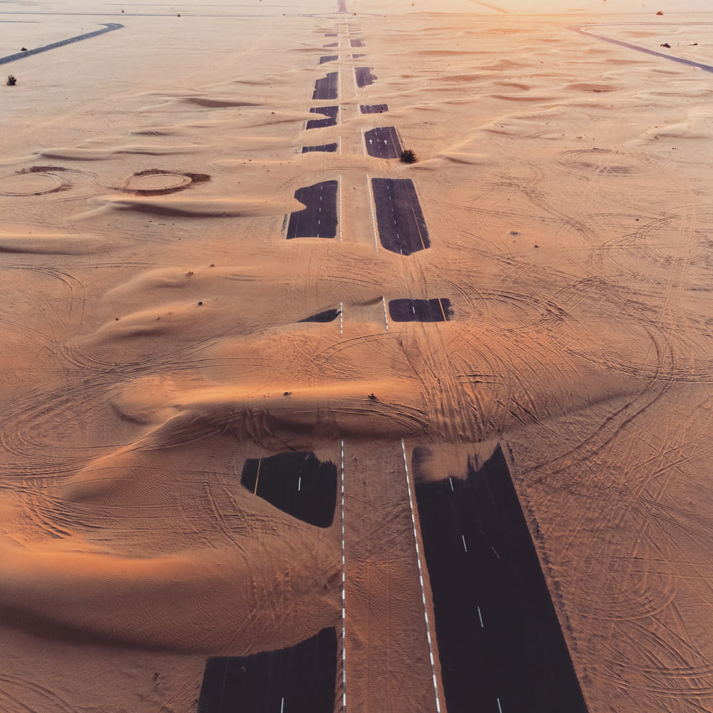an aerial view of a road in the desert