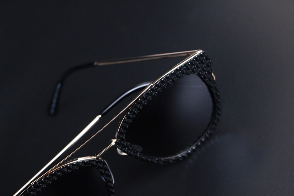a pair of sunglasses on a black surface