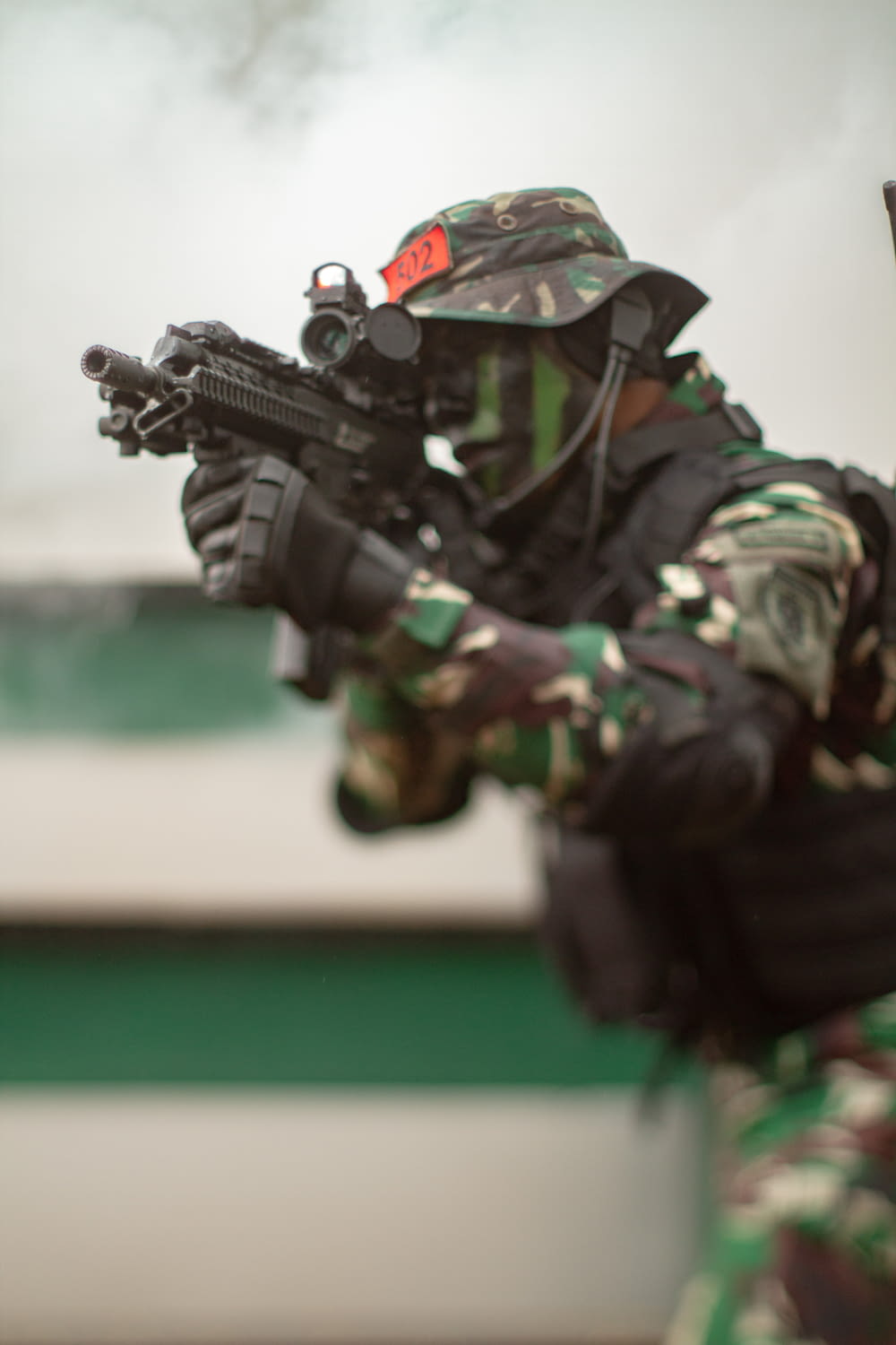 a man in camouflage holding a rifle