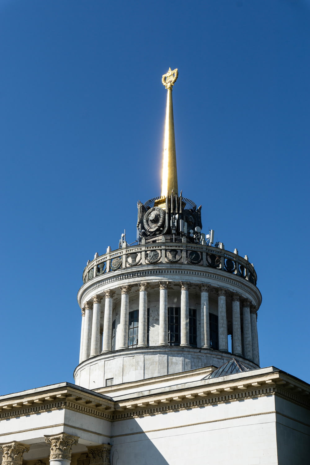 the top of a building with a golden cross on top