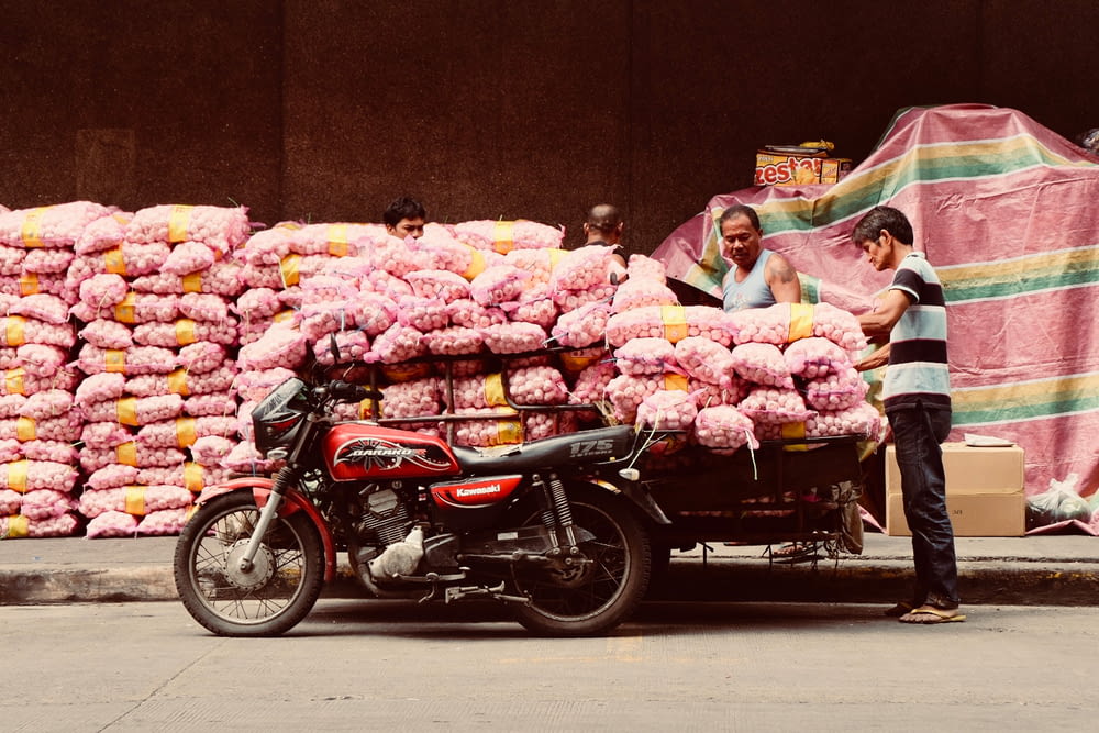 a motorcycle parked next to a pile of pink stuff