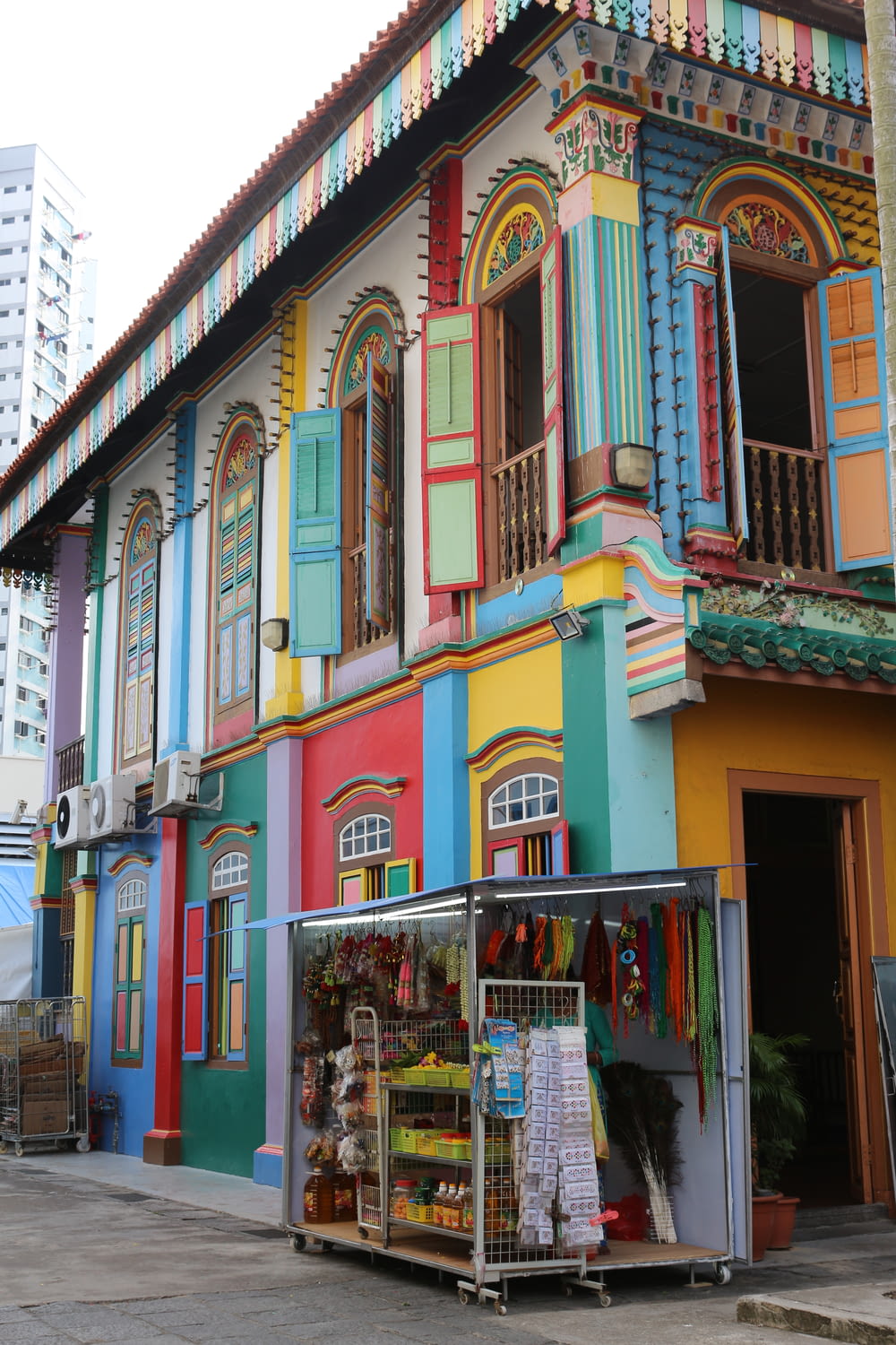 a colorful building with a fruit stand in front of it