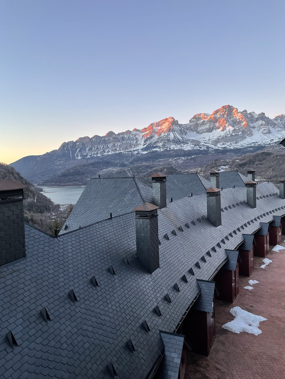 the roof of a building with mountains in the background