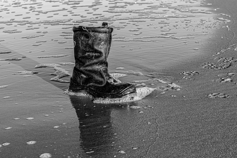 a pair of boots that are sitting in the sand