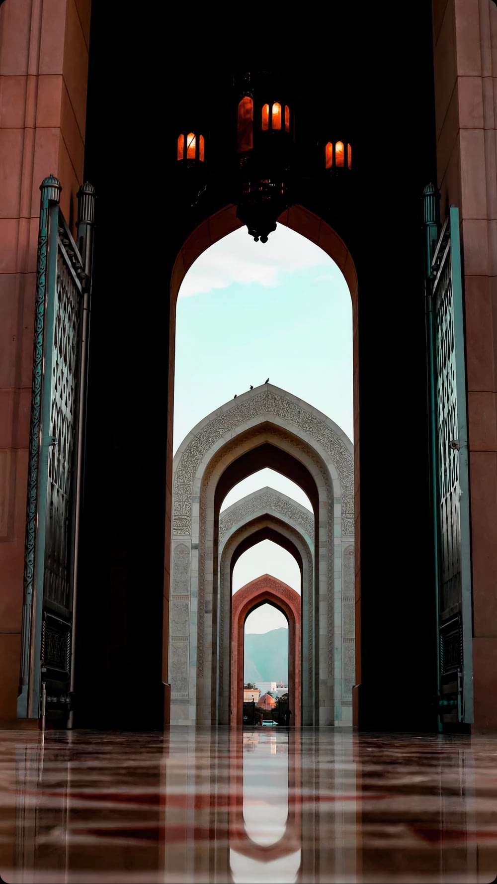 a large archway with a clock on top of it