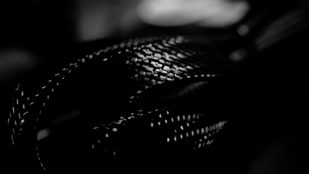 a black and white photo of a woven bag