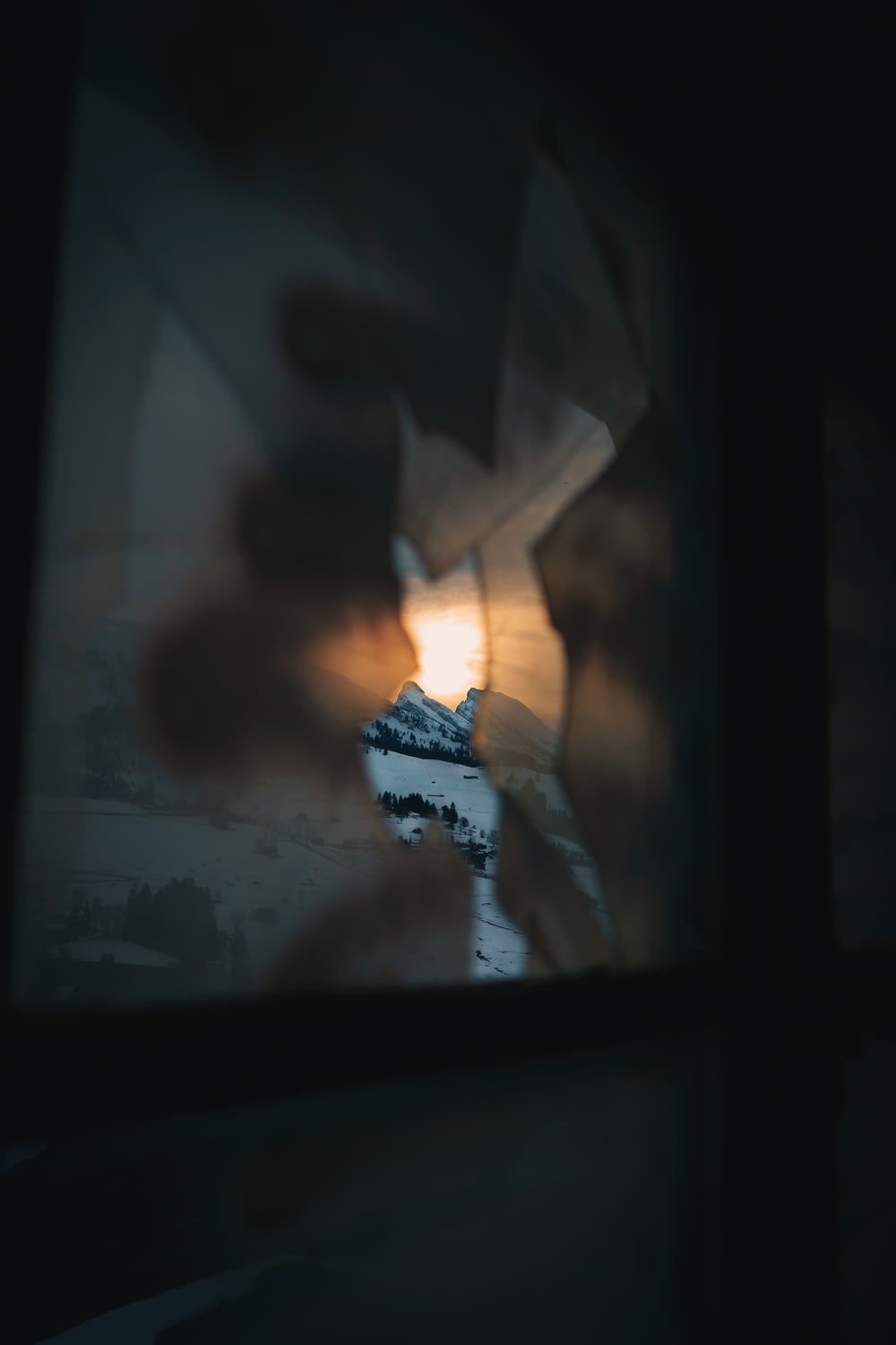 a blurry photo of a mountain seen through a window