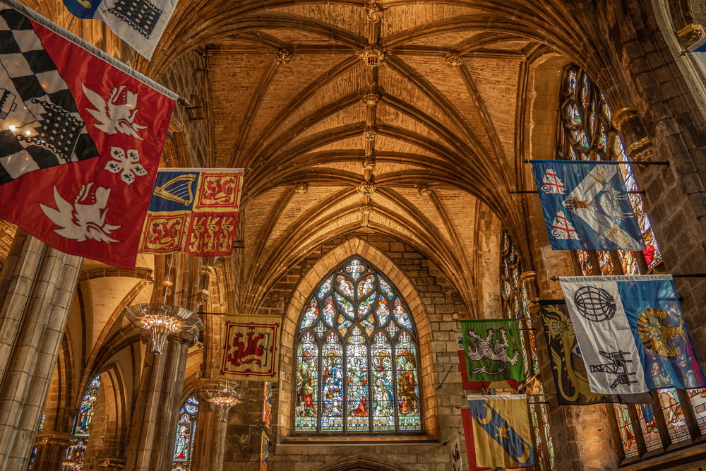 a large cathedral with flags hanging from the ceiling