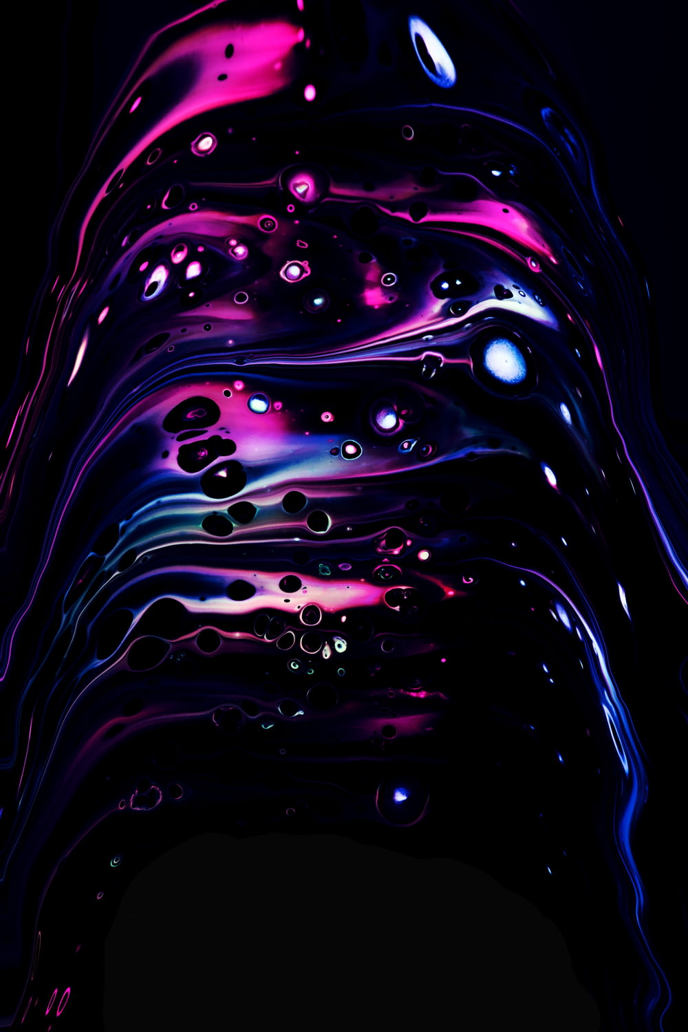 a black background with purple and blue liquid