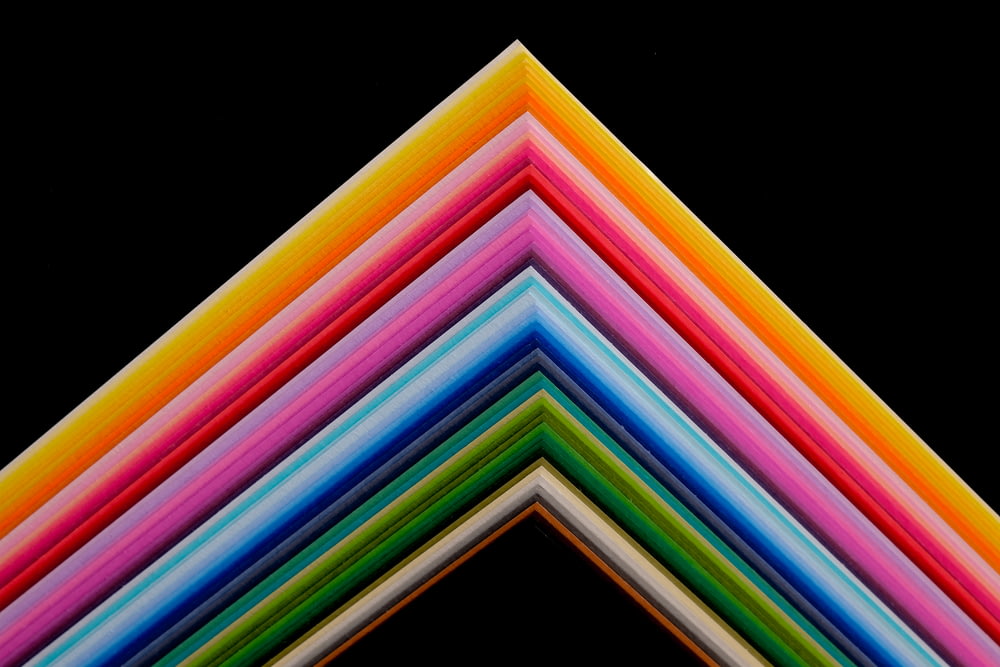 a group of multicolored papers stacked on top of each other