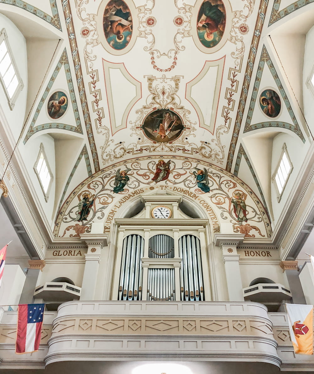 a church with a pipe organ and a flag hanging from the ceiling