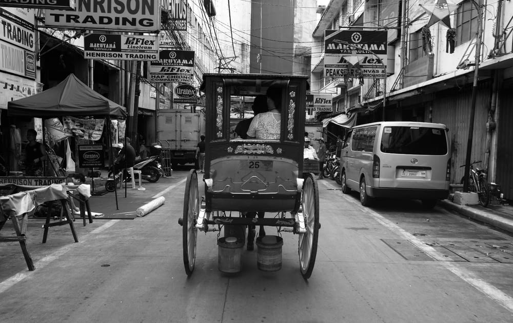 a horse drawn carriage driving down a street