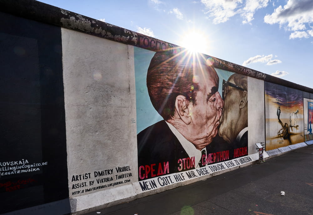 a mural of a man kissing a woman on the side of a building
