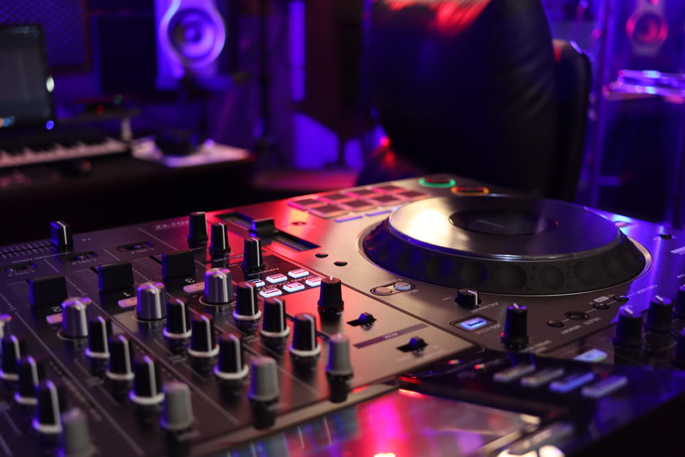 a dj mixing equipment in a dark room